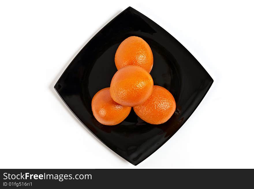 Fresh Oranges on black plate