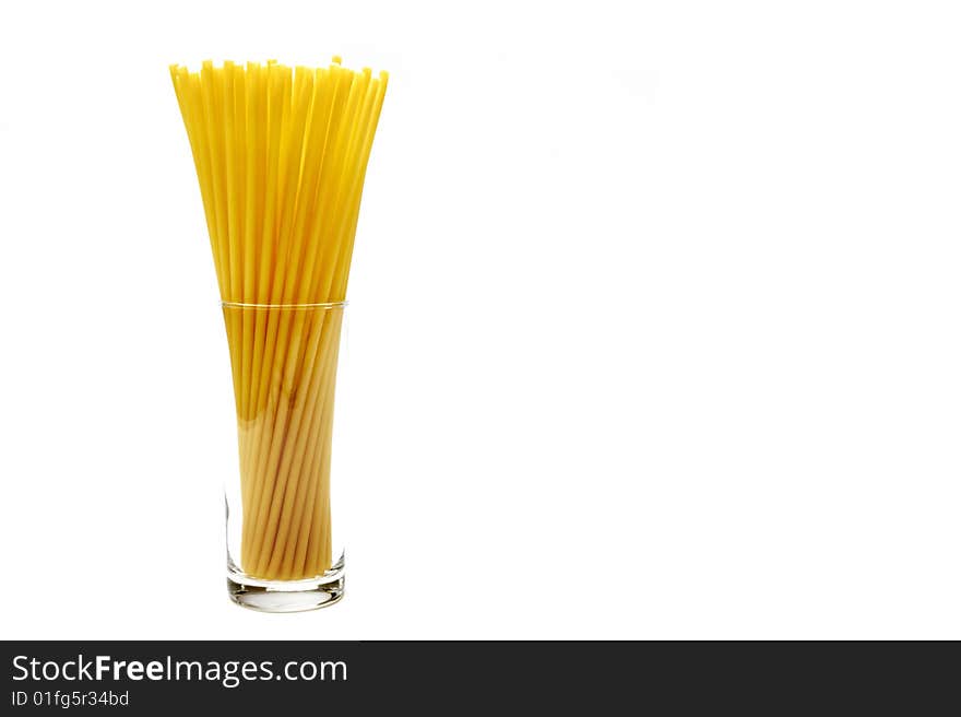 Spaghetti in glass on white background