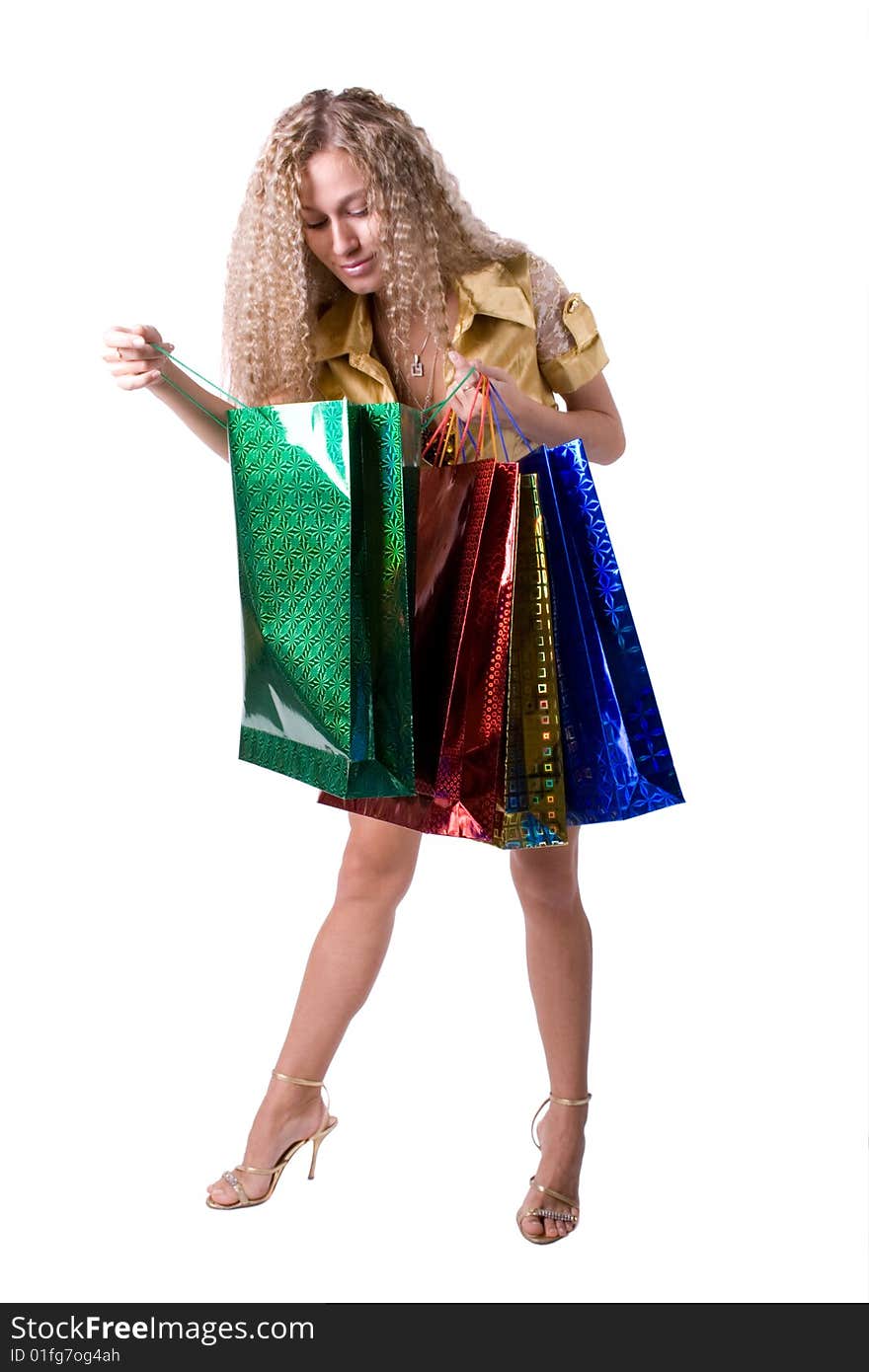 The young beautiful girl with purchases in colour packages during shopping on a white background