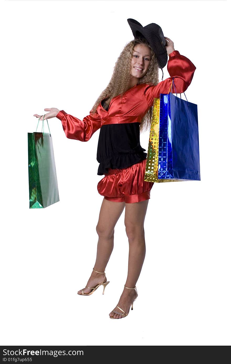 The young beautiful girl with purchases in colour packages during shopping on a white background