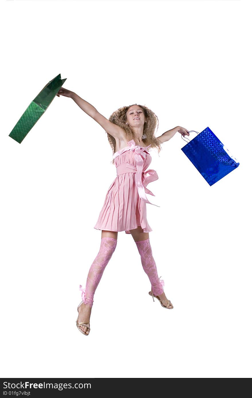 The young beautiful girl with purchases in colour packages during shopping on a white background