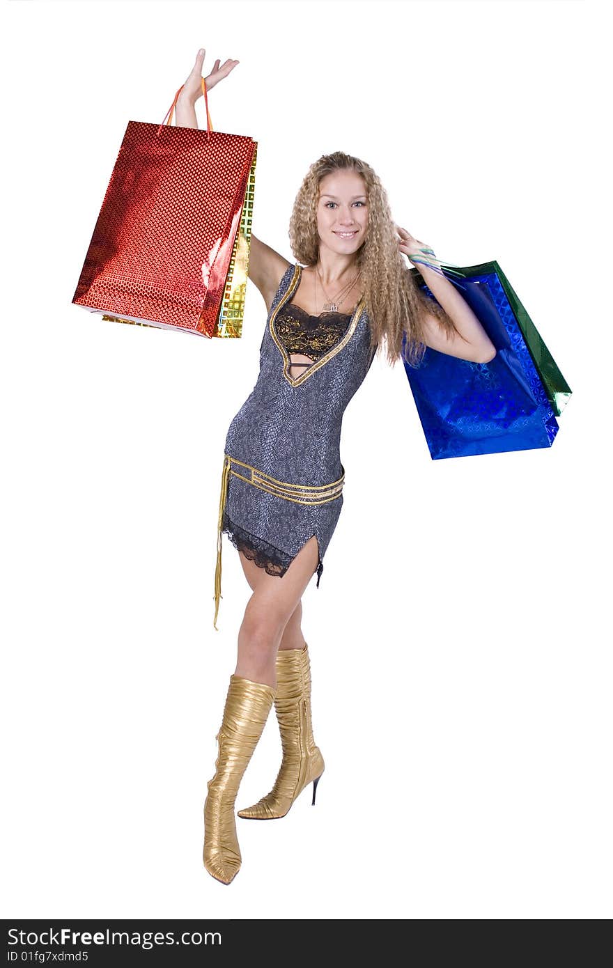 The young beautiful girl with purchases in colour packages during shopping on a white background