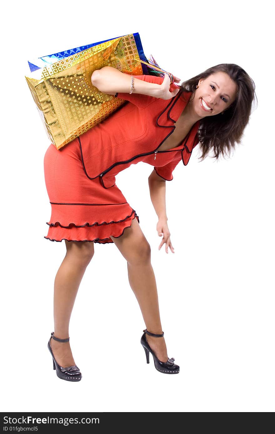 The young beautiful girl with purchases in colour packages during shopping on a white background