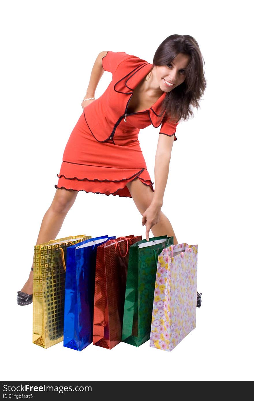 The young beautiful girl with purchases in colour packages during shopping on a white background