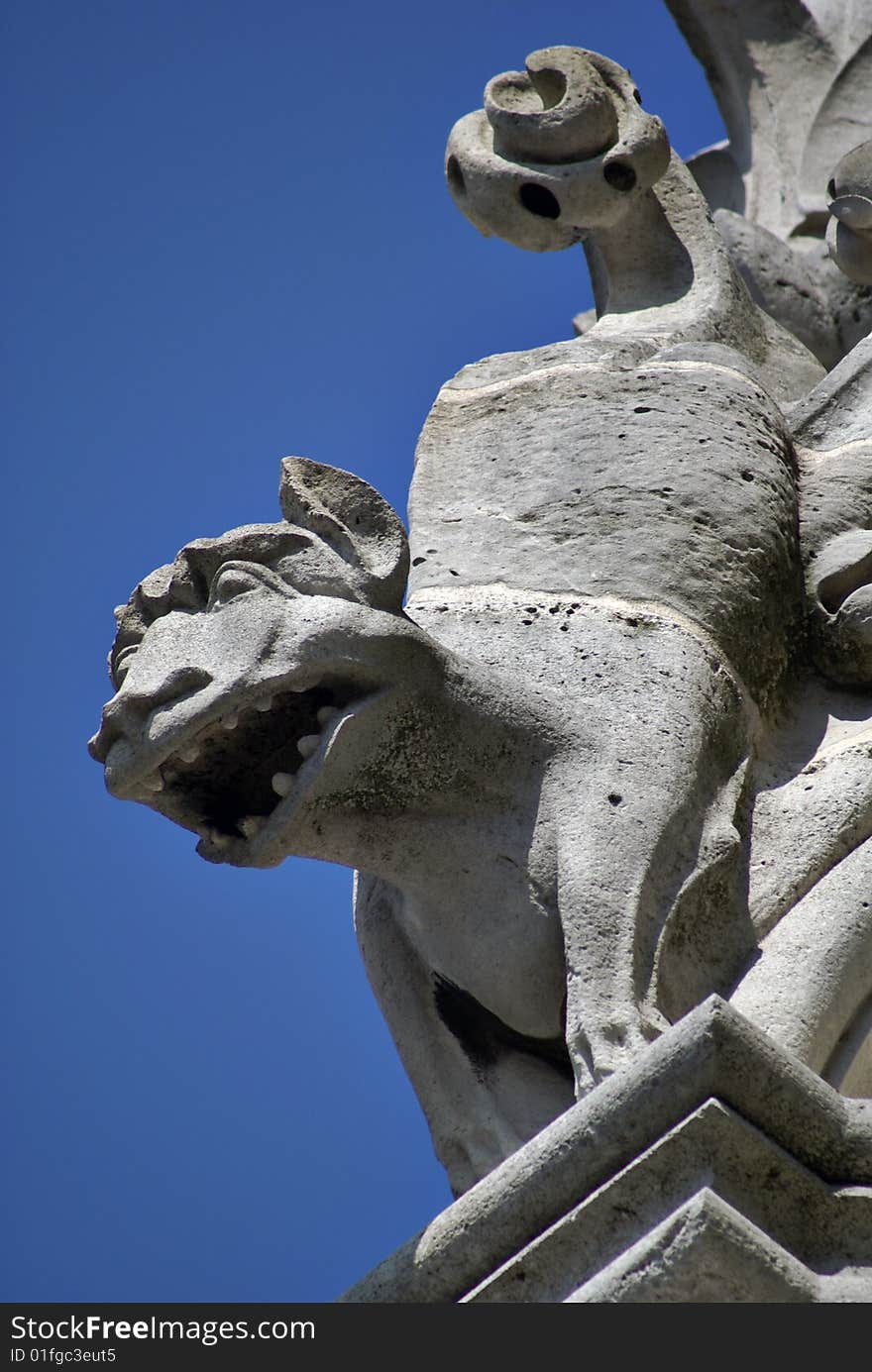 Frowning Gargoyle Against Blue Sky