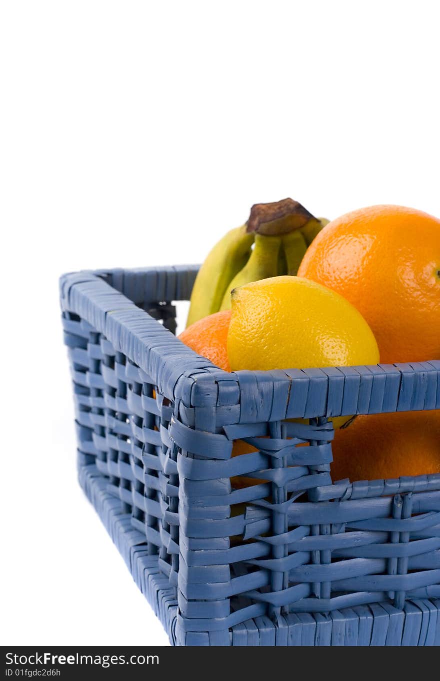 Blue basket with fruits on white background