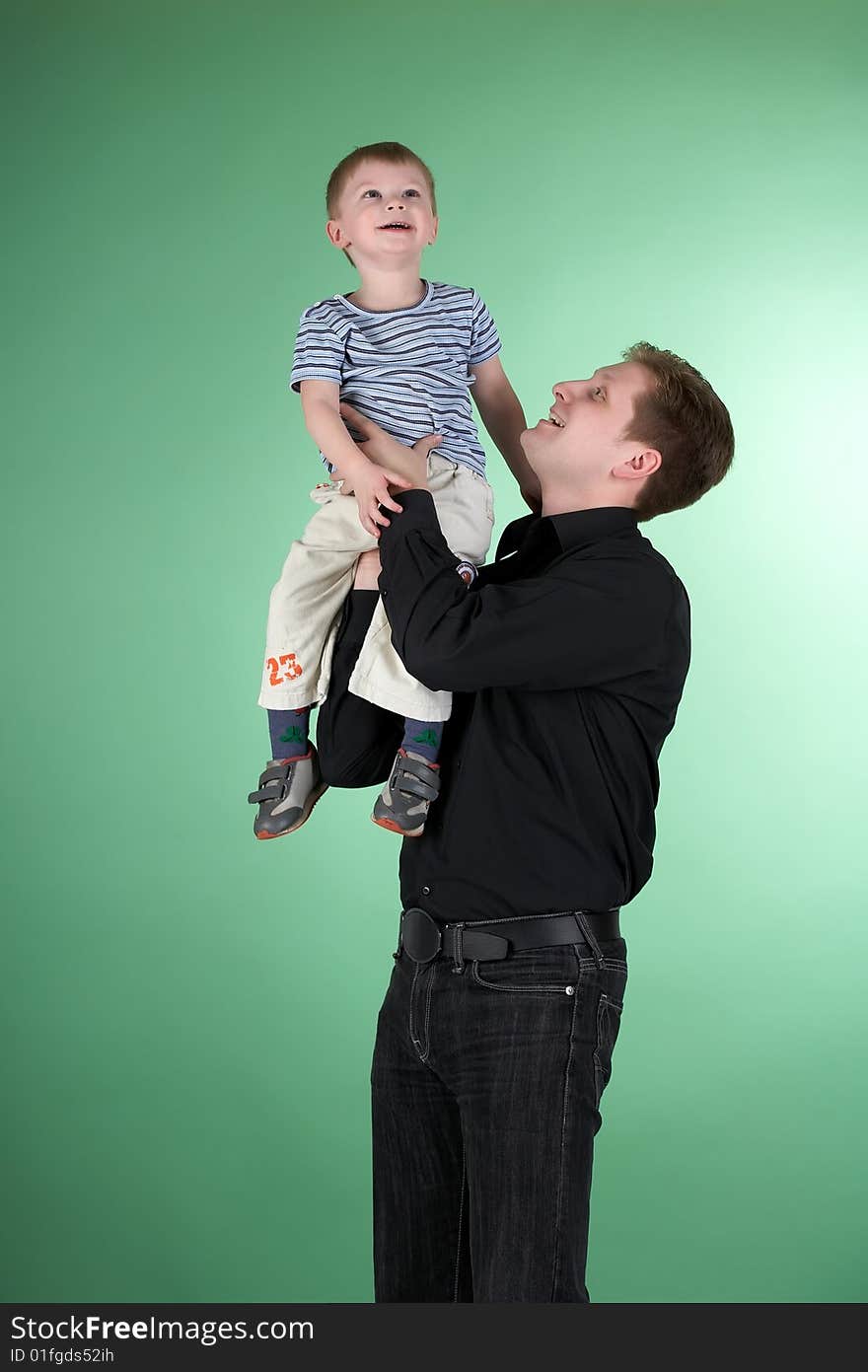 Dad and son on green background