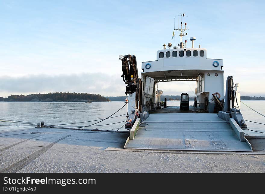 Small ferryboat moored at quay