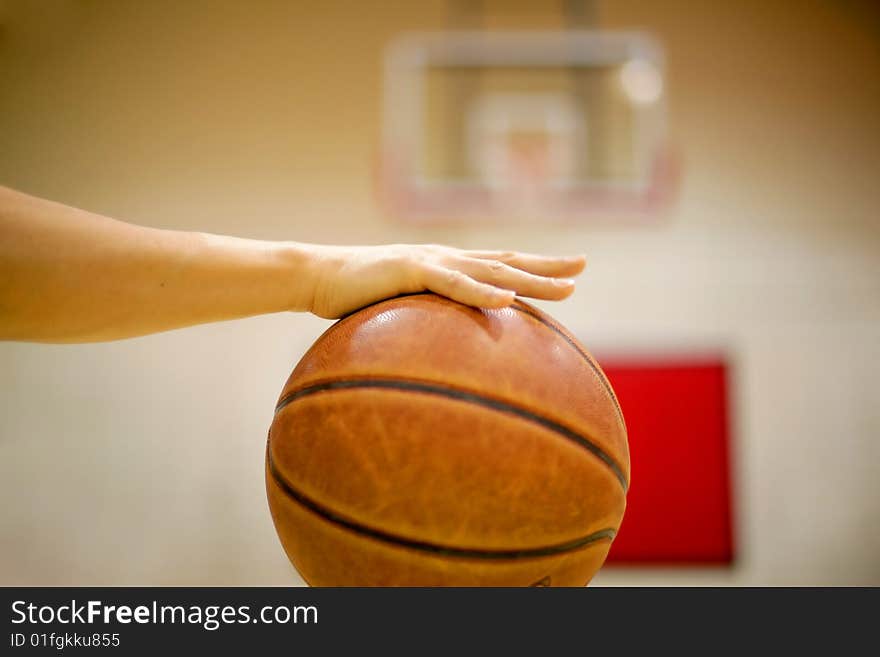 Basketball is controlled by the player, blurred backboard as background. Basketball is controlled by the player, blurred backboard as background