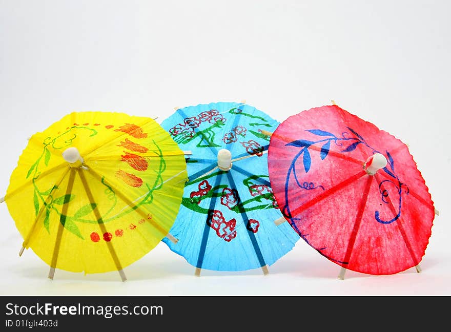 Paper umbrellas on white background