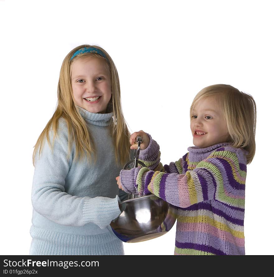 Sisters mixing and baking isolated on a white background