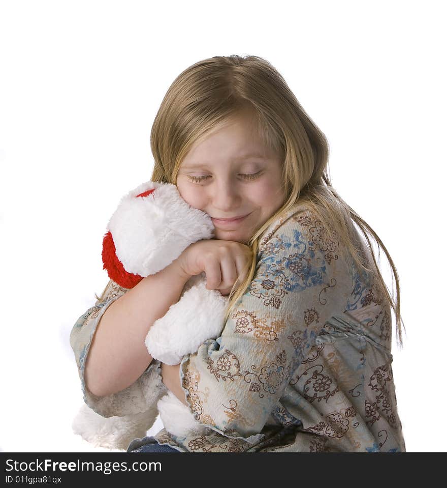 Girl hugging stuffed animal on white background