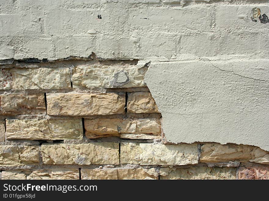 A crumbling plastered brick wall. A crumbling plastered brick wall.