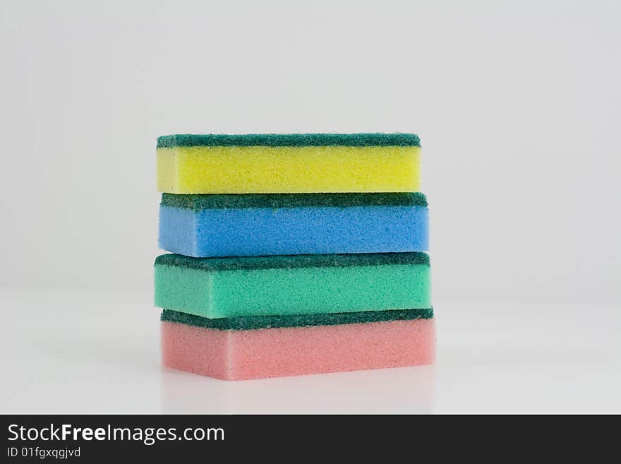 Heap of colorful sponges on a white background