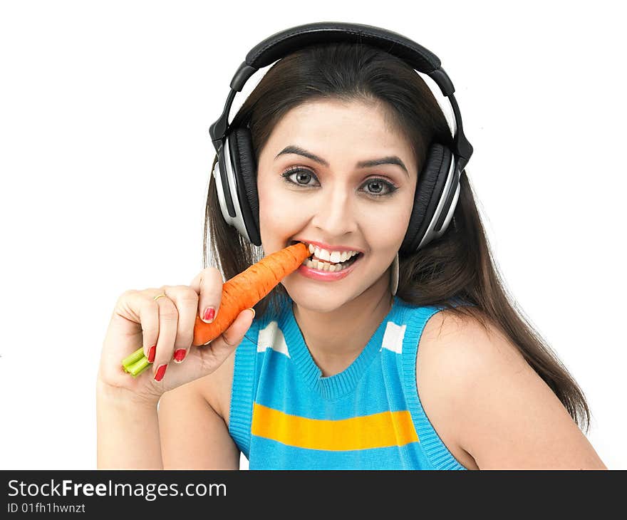 Beautiful young woman eating a carrot. Beautiful young woman eating a carrot