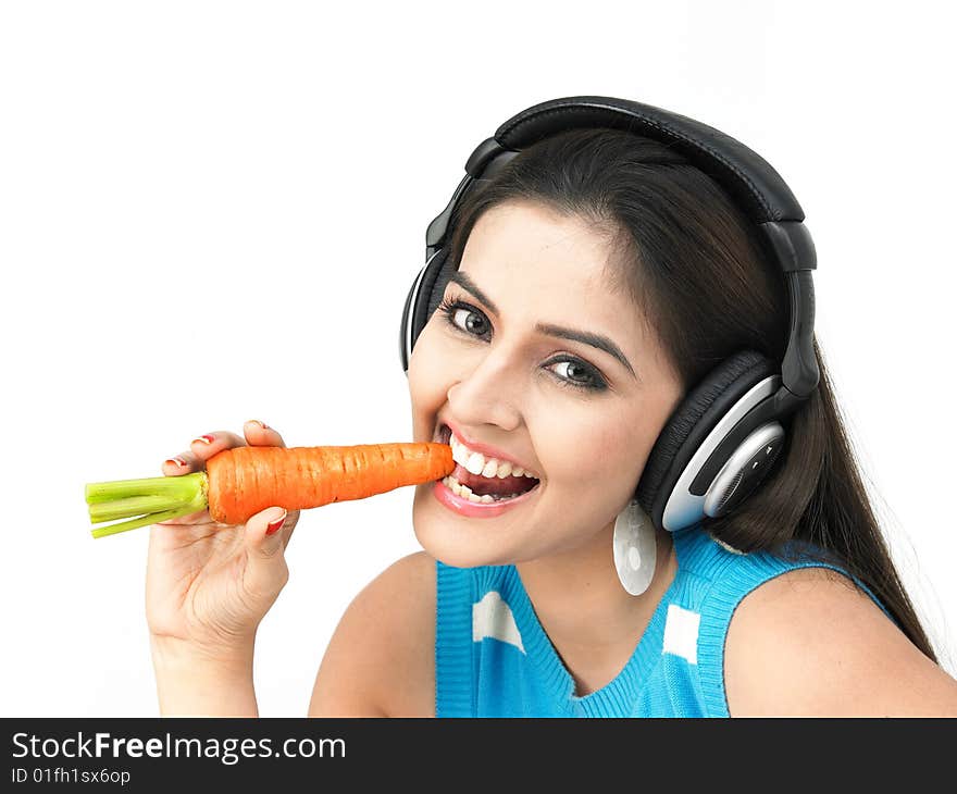 Beautiful young woman eating a carrot. Beautiful young woman eating a carrot