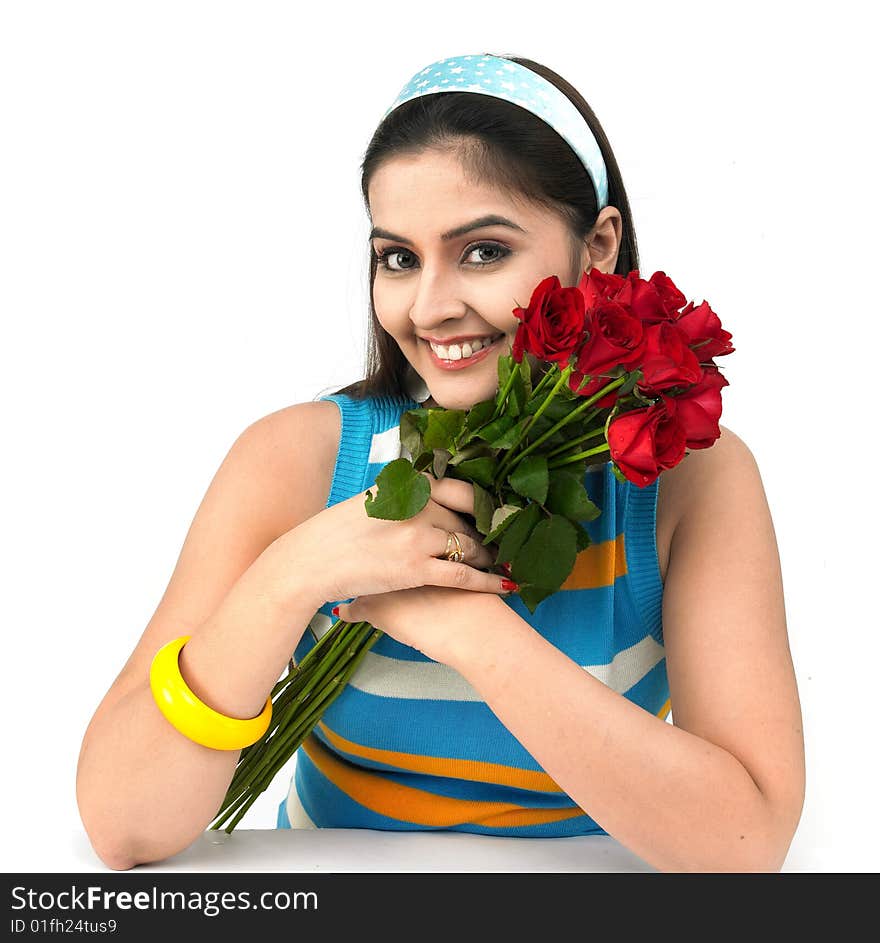 A smiling woman with a bouquet of red roses. A smiling woman with a bouquet of red roses