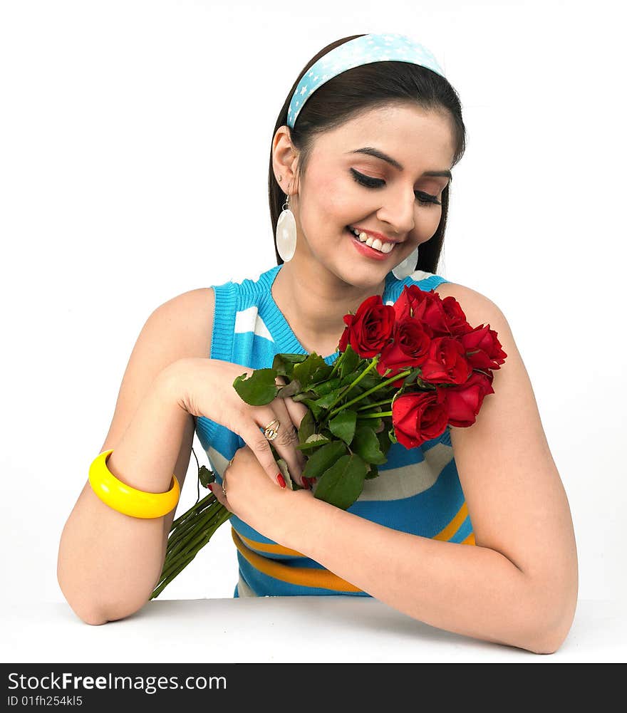 Beautiful young girl with a bouquet of red roses. Beautiful young girl with a bouquet of red roses