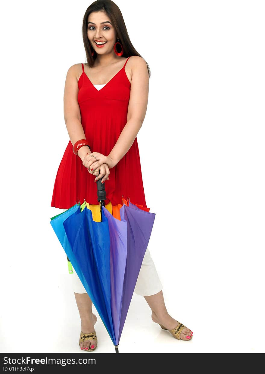 Smiling woman standing with a rainbow umbrella. Smiling woman standing with a rainbow umbrella