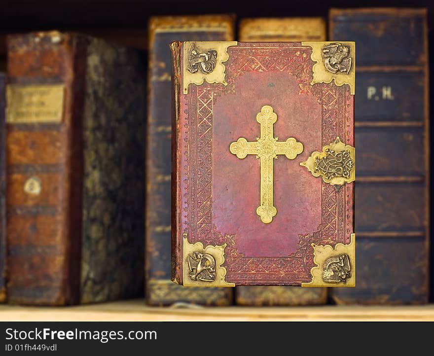 Old books and gilded Holy Bible