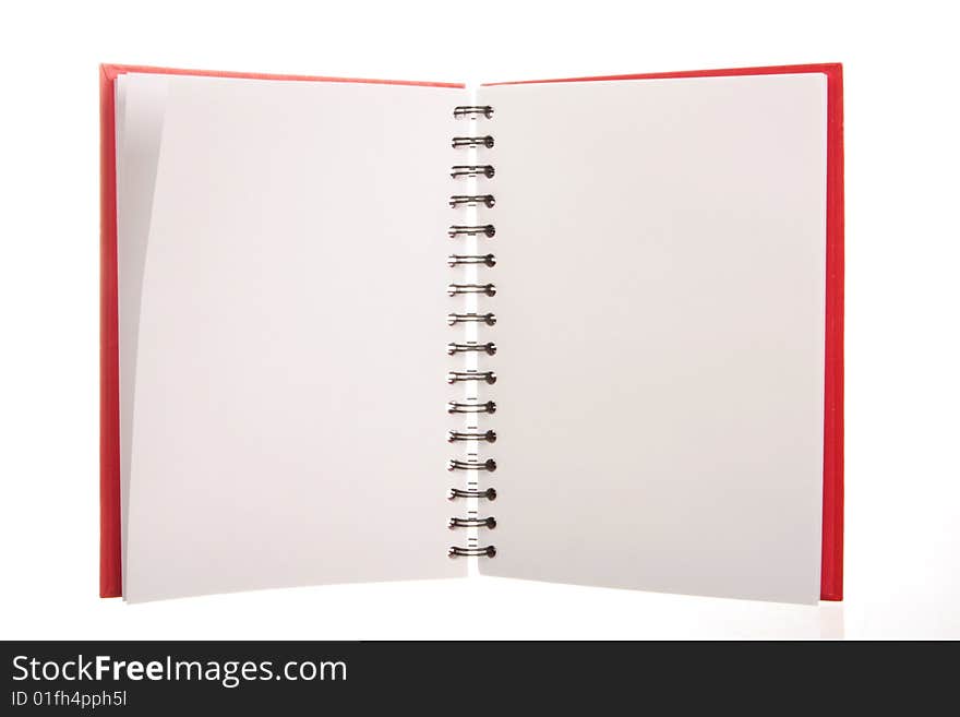 A red spiral notebook isolated on white, blank pages to put your own text or messages on