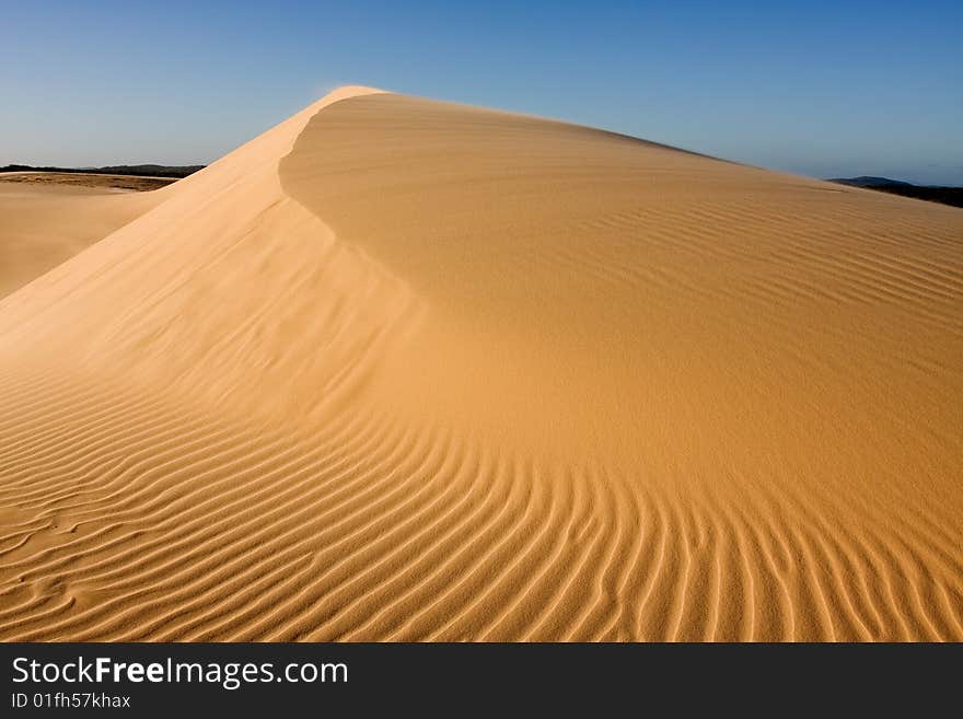 Stockton sand dunes in Anna Bay, NSW, Australia. Sand ripples detail with dramatic shadows. Taken in clear day conditions.