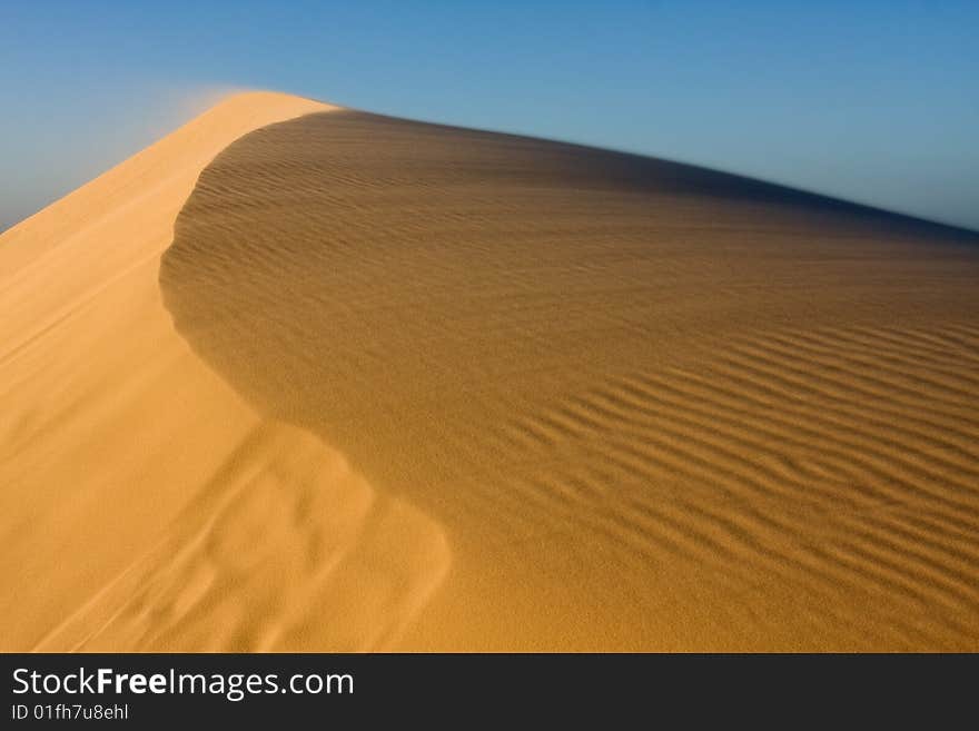 Stockton sand dunes in Anna Bay, NSW, Australia. Sand ripples detail with dramatic shadows. Taken in low light conditions.