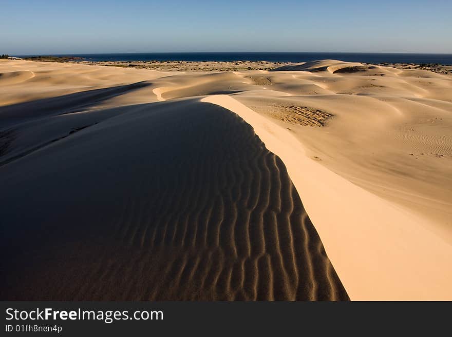 Stockton sand dunes in Anna Bay, NSW, Australia. Sand ripples detail with dramatic shadows. Taken in clean day conditions.