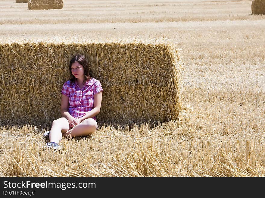 Young woman in haystack