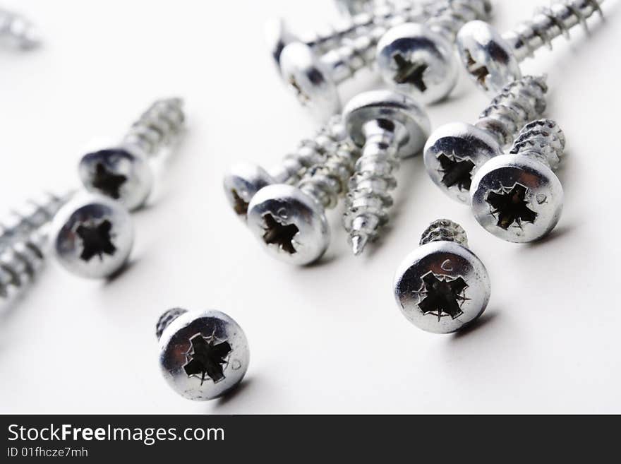 Many screws on white background