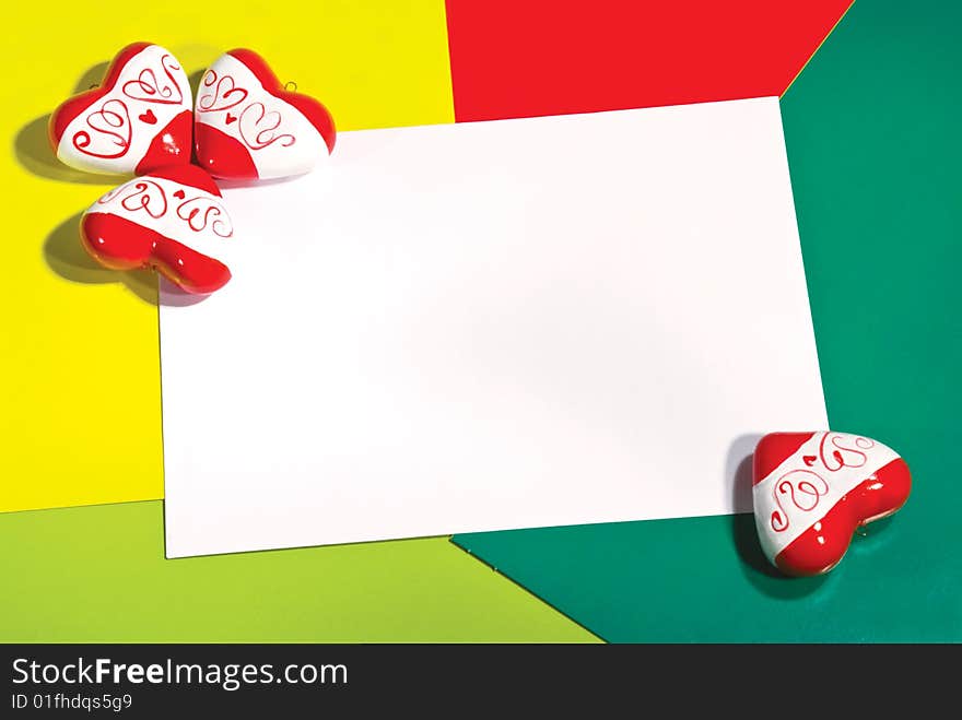 Greeting card with red hearts on color background