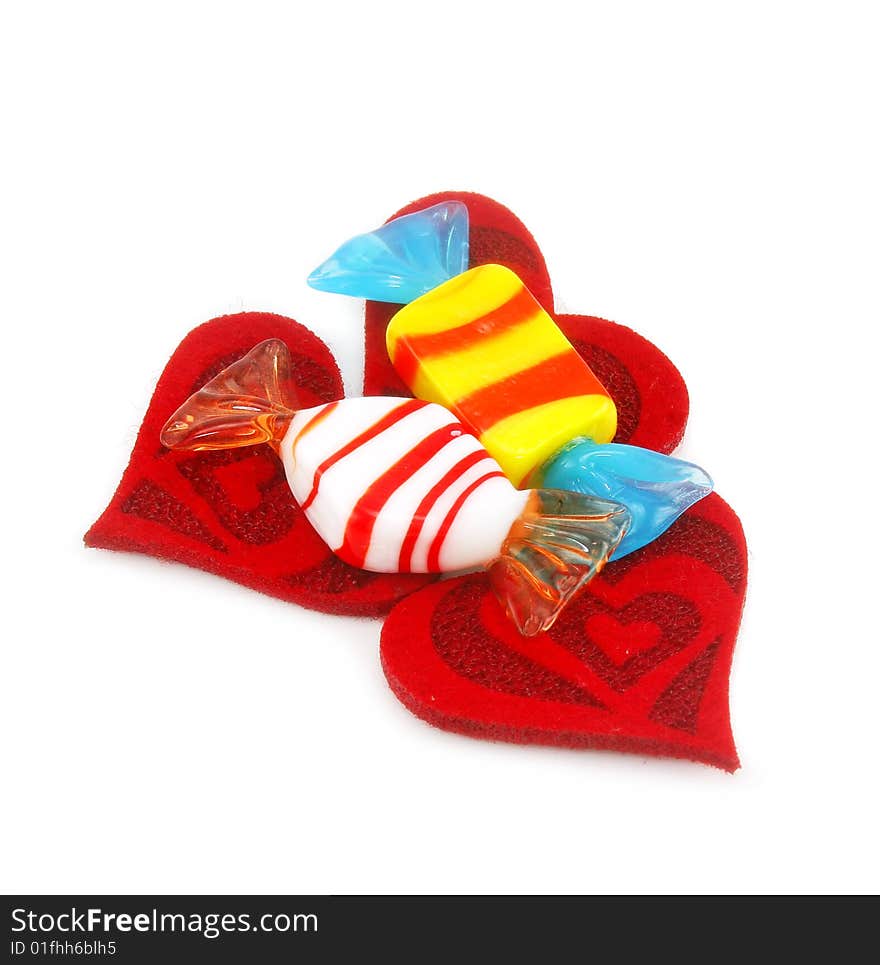 Three red hearts made of cloth and sweets isolated on a white background