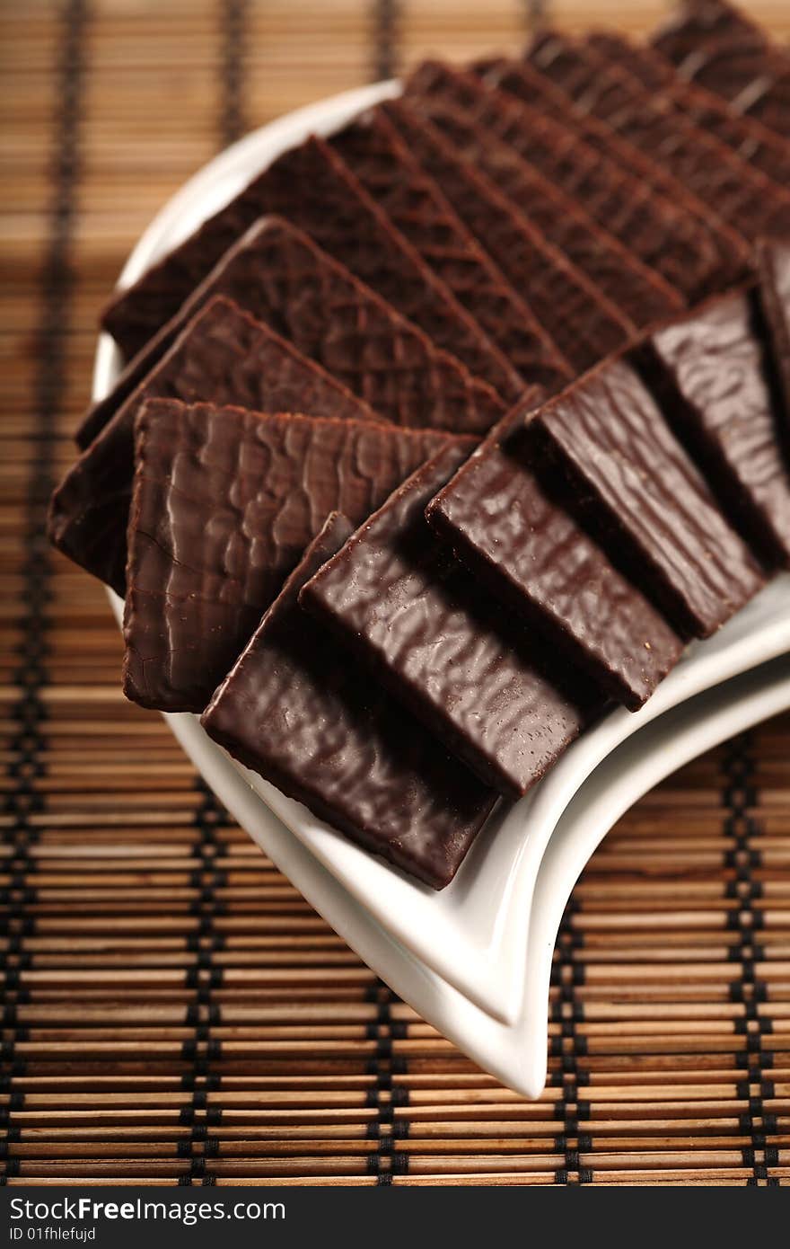 Chocolate cookies on white plates, close up