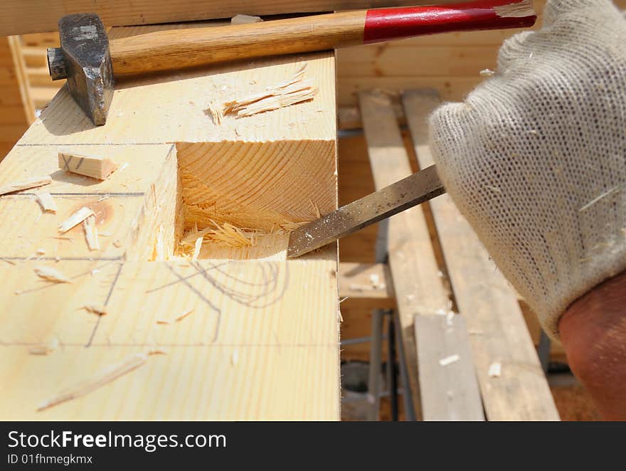 The carpenter makes dredging in a wooden wall. The carpenter makes dredging in a wooden wall.