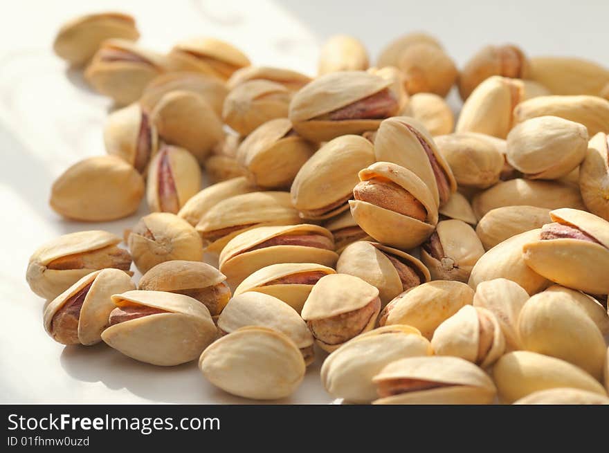 Handful of pistachios have been photographed with small DOF. Handful of pistachios have been photographed with small DOF.