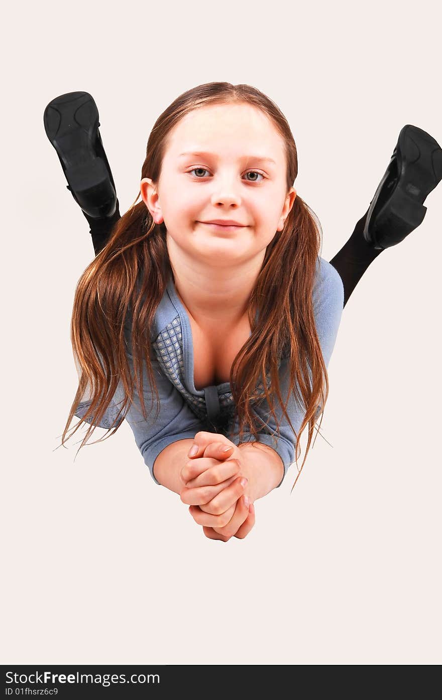 An little girl lying on her stomach on the floor of the studio and smiling
in the camera. An little girl lying on her stomach on the floor of the studio and smiling
in the camera.