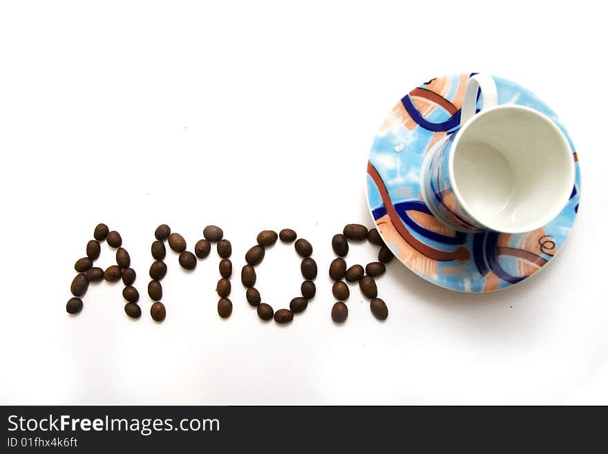 Inscription AMOR with coffee beans and a coffee cup. Inscription AMOR with coffee beans and a coffee cup