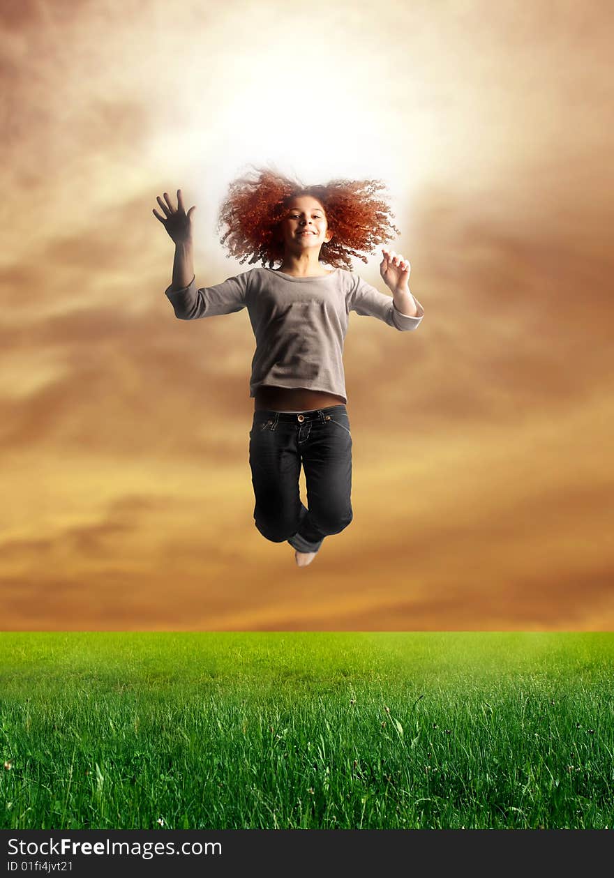 Portrait of a young teen jumping in a grass field