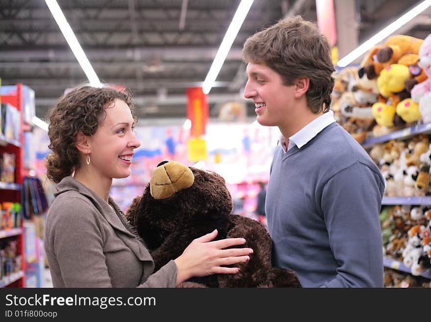 Smiling Couple in shop with soft toy