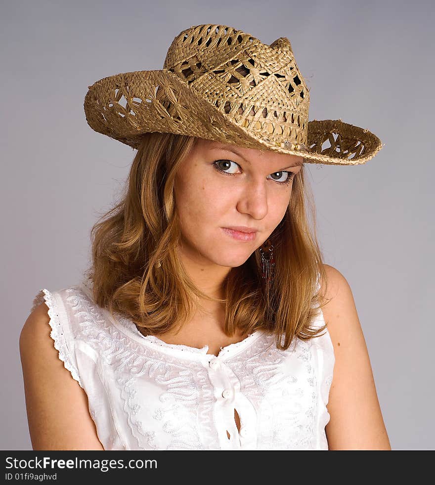 Portrait of young woman in a straw hat. Portrait of young woman in a straw hat