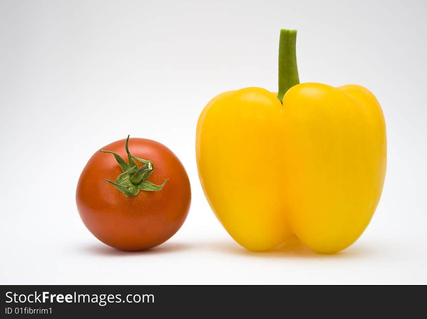 Tomato and paprika on the white background. Tomato and paprika on the white background.