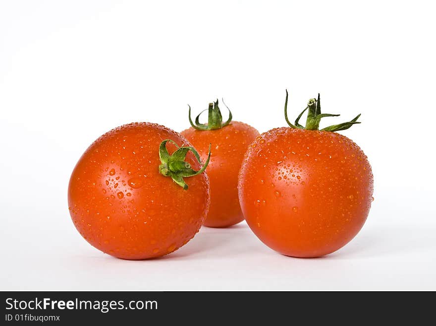 Three tomatoes on the white background.