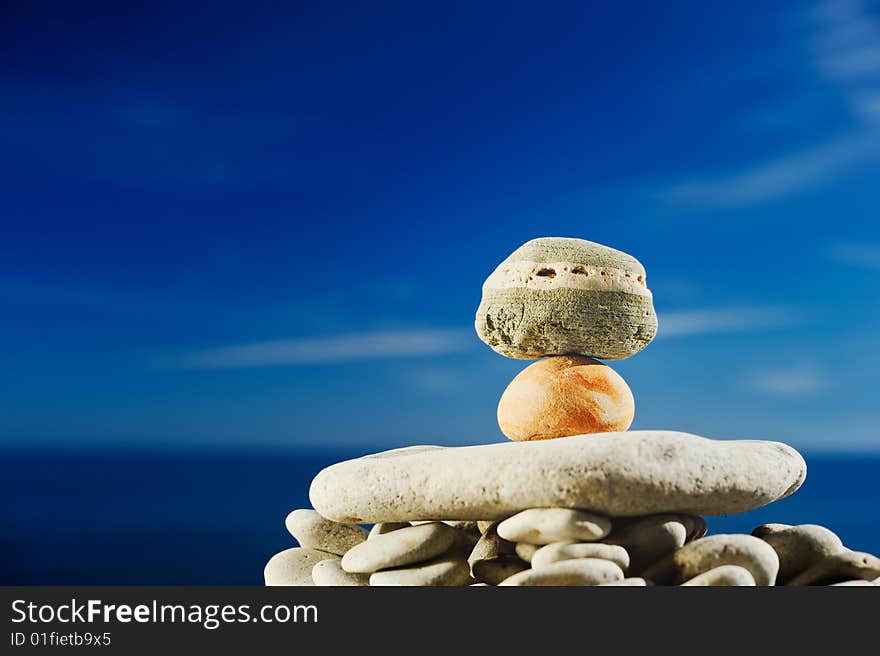 Sea pebble in bright light against the sky. Sea pebble in bright light against the sky