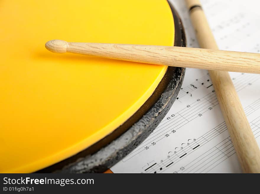 Pair of drumsticks, training pad and note paper