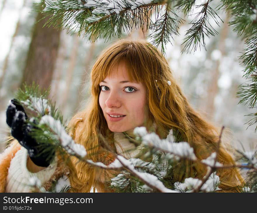 Red-heared girl in fur coat outdoors - shallow DOF. Red-heared girl in fur coat outdoors - shallow DOF