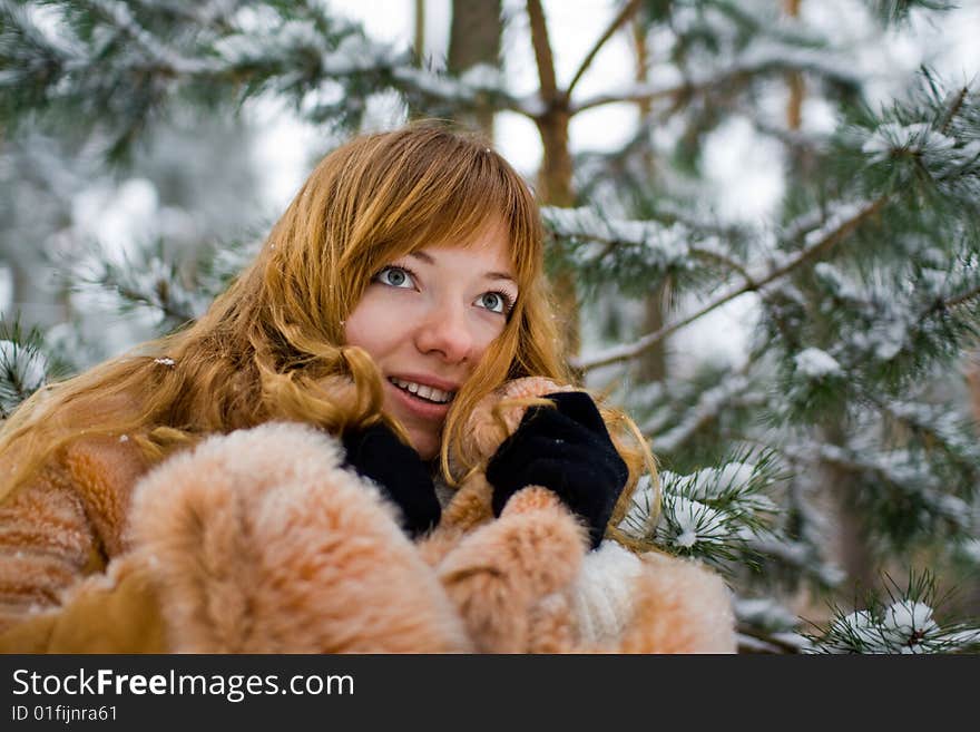 Red-heared girl in fur coat outdoors - shallow DOF. Red-heared girl in fur coat outdoors - shallow DOF