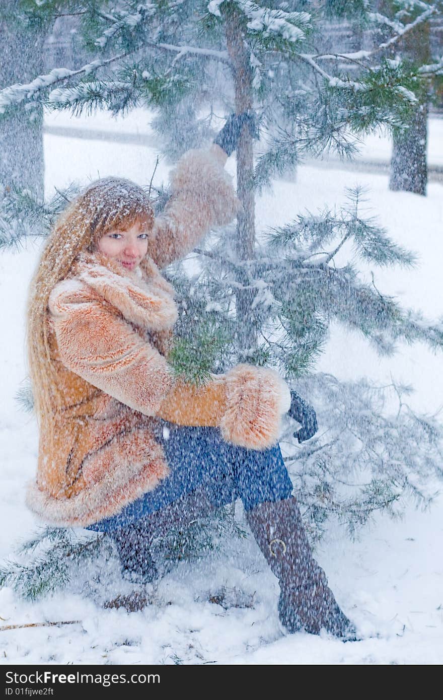 Red-heared girl in short fur coat outdoors - shallow DOF. Red-heared girl in short fur coat outdoors - shallow DOF