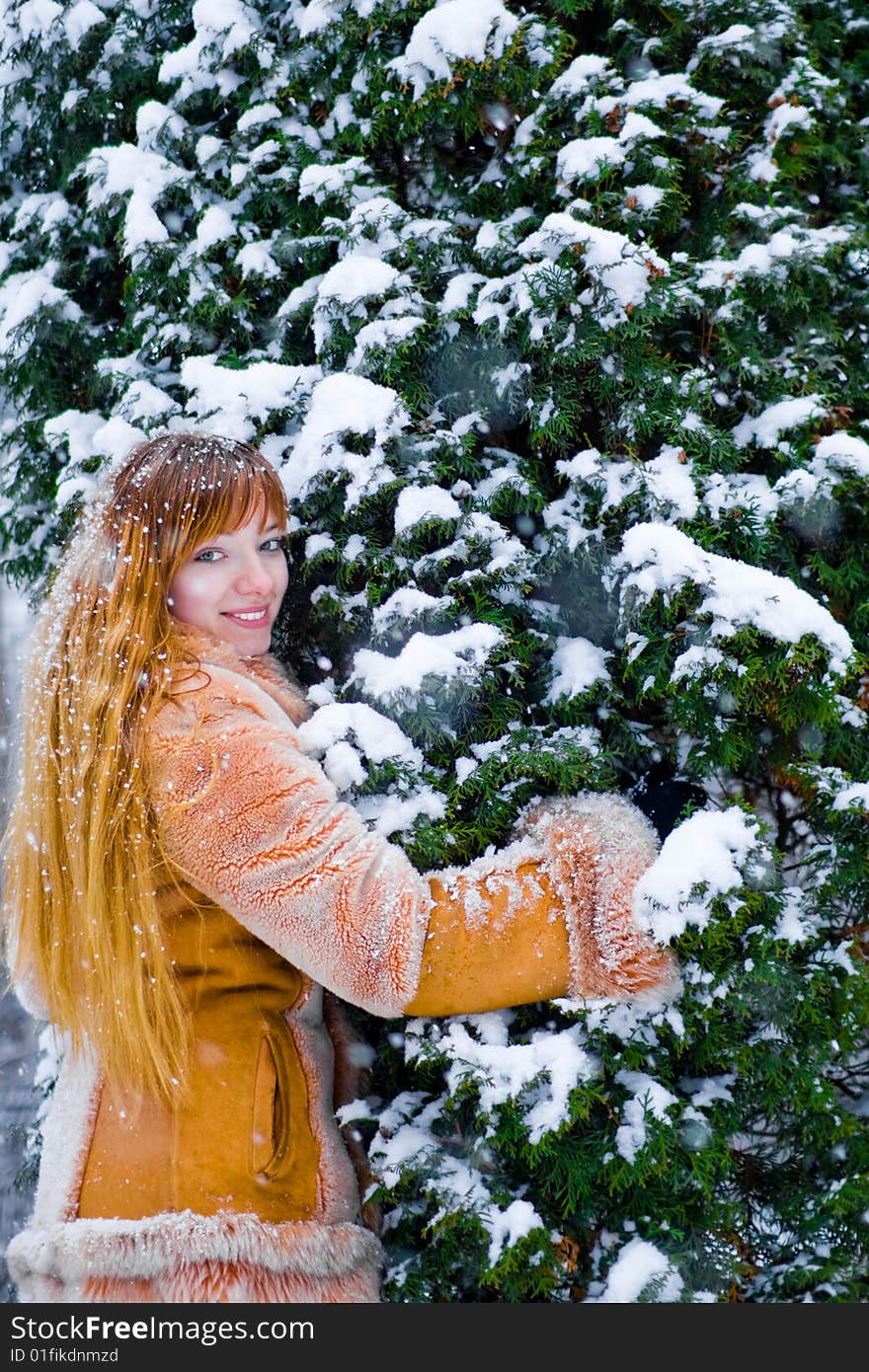 Red-heared girl in fur coat outdoors - shallow DOF. Red-heared girl in fur coat outdoors - shallow DOF