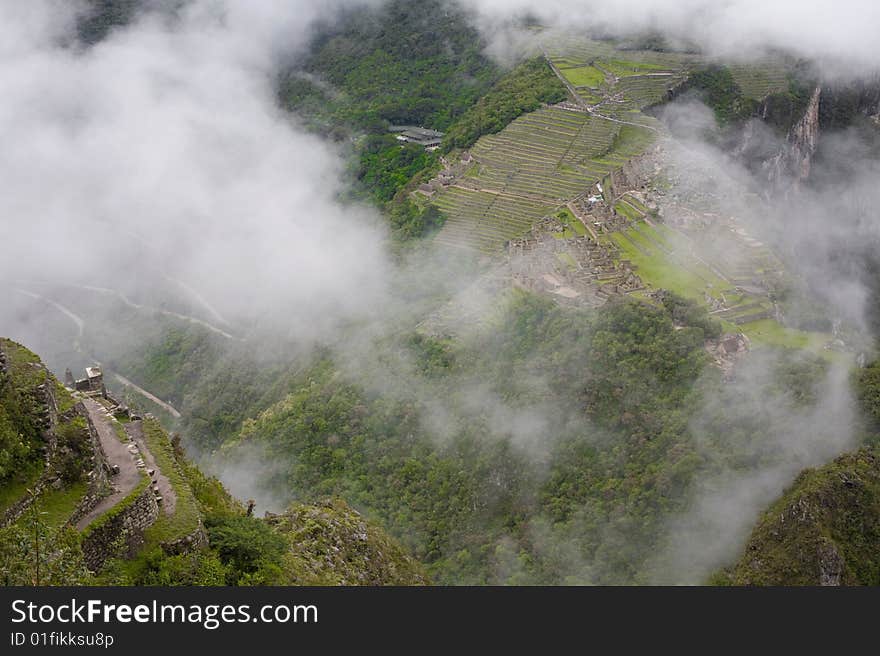 Machu Picchu is a pre-Columbian Inca site located 2,430 metres (8,000 ft) above sea level. It is situated on a mountain ridge above the Urubamba Valley in Peru, which is 80 kilometres (50 mi) northwest of Cusco and through which the Urubamba River flows. The river is a partially navigable headwater of the Amazon River. Often referred to as The Lost City of the Incas, Machu Picchu is one of the m