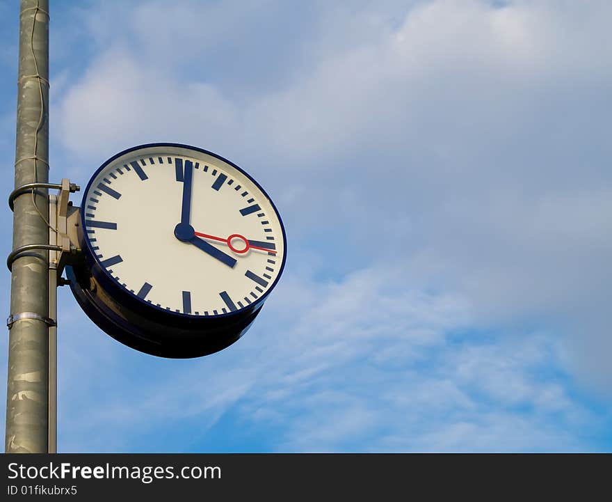 Classic clock  on blue sky.